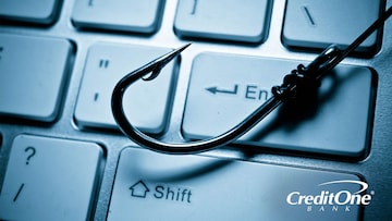 A fishing hook resting on a keyboard - don't get phished